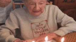 Animated Gif showing: Grandma Loses Dentures Blowing Out Birthday Candles